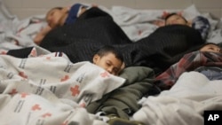 Detainees sleep in a holding cell at a U.S. Customs and Border Protection building in Brownsville,Texas, June 18, 2014. 
