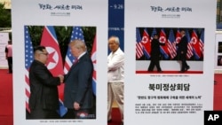 Photos of the summit between U.S. President Donald Trump and North Korean leader Kim Jong Un are displayed during a photo exhibition to wish for peace on the Korean Peninsula in Seoul, South Korea, Wednesday, Sept. 19, 2018. 