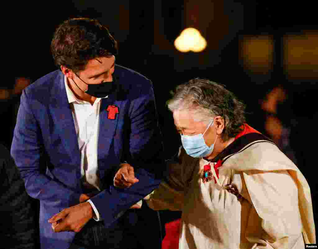 Prime Minister Justin Trudeau escorts Inuk survivor Elder Levinia Brown on the eve of Canada&#39;s first National Day for Truth and Reconciliation, honoring the lost children and survivors of Indigenous residential schools, their families and communities on Parliament Hill in Ottawa, Ontario, Sept. 29, 2021