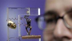 Senior curator Dag Spicer looks at a replica of the first transistor at the Computer History Museum in Mountain View, California