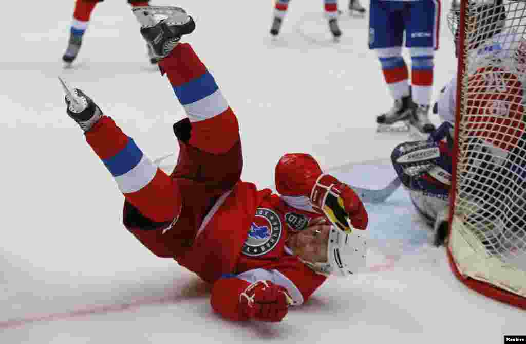 Russian President Vladimir Putin falls as he takes part in a gala match of the hockey teams of the Night League at the Shayba Olympic Arena in Sochi, Russia, May 10, 2017..