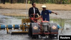 Thailand's Prime Minister Prayuth Chan-ocha rides on a tractor at a farmer school in Suphan Buri province, Thailand, Sept. 18, 2017.