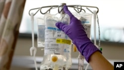 FILE - A nurse places chemotherapy medication on an intravenous stand at the Fox Chase Cancer Center in Philadelphia.