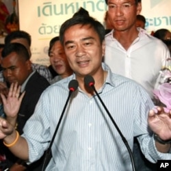 Thai Prime Minister and leader of Democrat Party Abhisit Vejjajiva gestures during a news conference at the party's headquarters Sunday, July 3, 2011 in Bangkok, Thailand