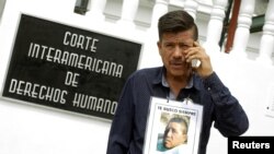 Jaime Alvarado displays a portrait of his brother Jose Angel Alvarado, who went missing in 2009, allegedly as a result of human rights violations by the Mexico military, during a hearing convened by the judges of the Inter-American Court of Human Rights in San Jose, Costa Rica, April 26, 2018.