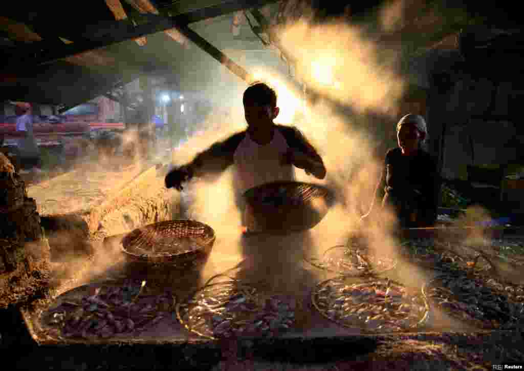 A worker is seen marinating fish at Cilincing district in Jakarta, Indonesia.