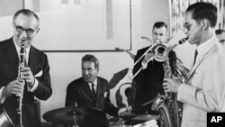 FILE - In this July 5, 1960, file photo, Thailand's King Bhumibol Adulyadej, right, plays the saxophone during a jam session with legendary jazz clarinetist Benny Goodman, left, drummer Gene Krupa, second left, and trombonist Urbie Green