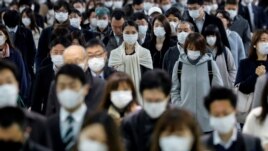 People wear face masks at Shinagawa station during the rush hour after the government expanded a state of emergency to include the entire country following the coronavirus disease (COVID-19) outbreak, in Tokyo, Japan, April 20, 2020.