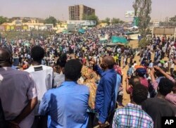 Protesters rally at a demonstration near the military headquarters, April 9, 2019, in the capital Khartoum, Sudan.