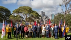 Britain's Prince Harry, center, and his wife Meghan, the Duchess of Sussex, center right, meet the Australian Governor-General Sir Peter Cosgrove and Lady Cosgrove, and representatives of Invictus Games participating countries in Sydney, Tuesday, Oct. 16, 2018. 
