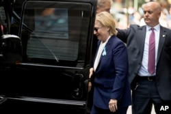 Democratic presidential candidate Hillary Clinton gets into a van as she departs an apartment building Sunday, Sept. 11, 2016, in New York. Clinton's campaign said the Democratic presidential nominee left the 9/11 anniversary ceremony in New York early after feeling "overheated."