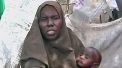 Woman & her child in the Badbaado IDP refugee camp in Mogadishu, Somalia.