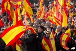 People wave Spanish flags during a rally by the right wing VOX party in Madrid, Dec. 1, 2018. VOX supporters waved Spanish flags as they gathered in Colon Square to listen to speeches from party leaders.
