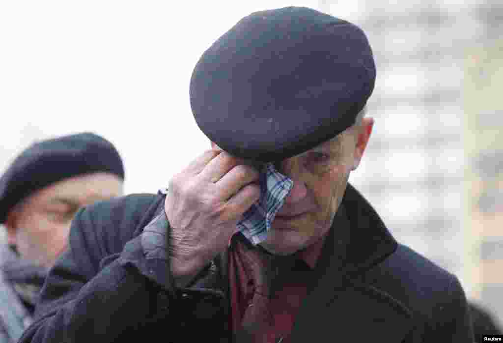 A man wipes away tears as he waits to attend a memorial service before the funeral of Russian leading opposition figure Boris Nemtsov in Moscow, March 3, 2015.