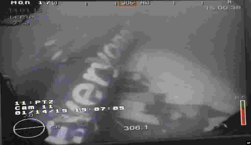 This undated underwater photo taken by a Remotely Operated Vehicle (ROV) and released by the Singapore Ministry of Defense (MINDEF) shows the wreckage of AirAsia Flight 8501 lying on the floor of the Java Sea, Jan. 14, 2015.
