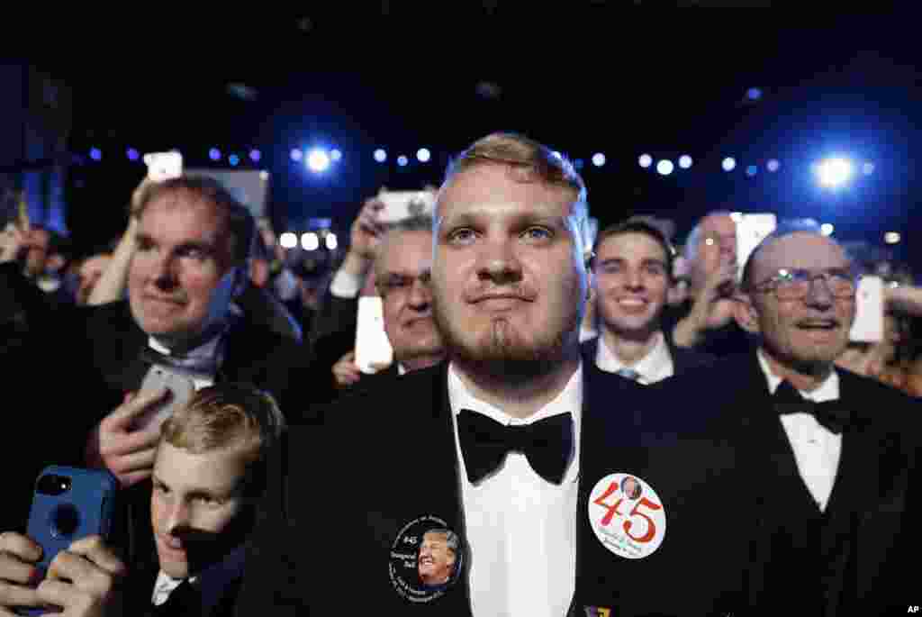 People listen to President Donald Trump speak at the Freedom Ball, Jan. 20, 2017, in Washington. 