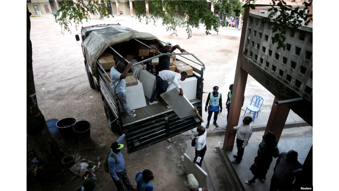 Employees of Congo's Independent National Electoral Commission (CENI) deliver voting machines and materials to a polling station in Kinshasa, Democratic Republic of Congo, Dec. 27, 2018.