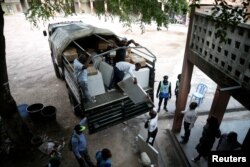 Employees of Congo's Independent National Electoral Commission (CENI) deliver voting machines and materials to a polling station in Kinshasa, Democratic Republic of Congo, Dec. 27, 2018.