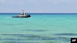 A boat of Taiwan's coast guard is seen off the Dongsha Island, on Wednesday July 23, 2008. Concrete pilings designed to prevent an invasion no longer dot this tiny Taiwanese islet's shoreline.