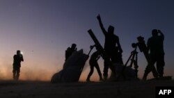 Fighters from the Free Syrian Army cheer and react as they fight against Islamic State group jihadists on the outskirts of the northern Syrian town of Dabiq, Oct. 15, 2016.