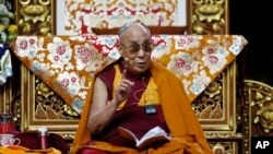 The Dalai Lama Tenzin Gyatso delivers his message as he attends a fair in Milan.