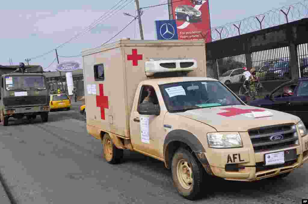 Liberian soldiers in a medical truck with a posted sign on it that reads &#39;Ebola Must Go,&#39; as it drives around the city to help prevent panic, Monrovia, Liberia, August 1, 2014.&nbsp;