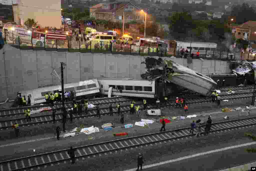 Emergency personnel respond to a train derailment in Santiago de Compostela, Spain, July 24, 2013.