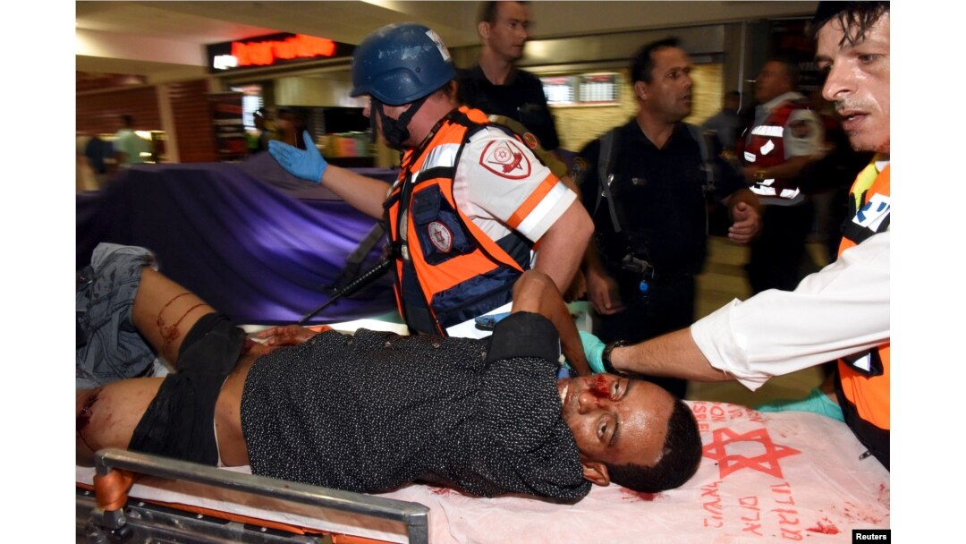 An injured man receives treatment at the Beersheba central bus station, where a Palestinian gunman went on a stabbing and shooting rampage, Oct. 18, 2015.