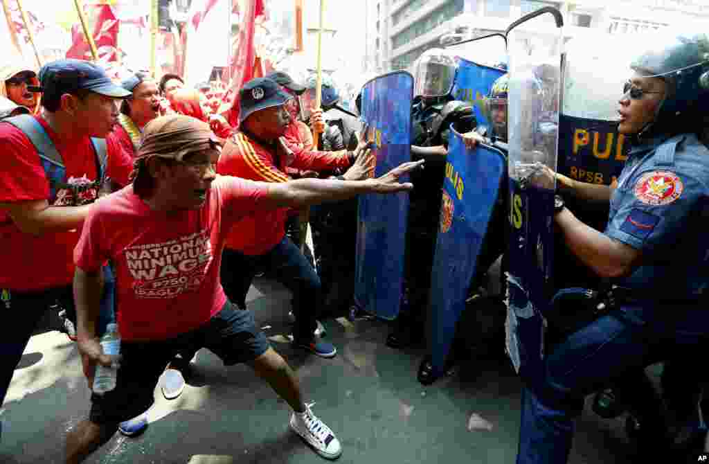 Protesters clash with riot police as they attempt to force their way closer to the U.S. Embassy to mark the global celebration of May Day in Manila, Philippines Monday, May 1, 2017.