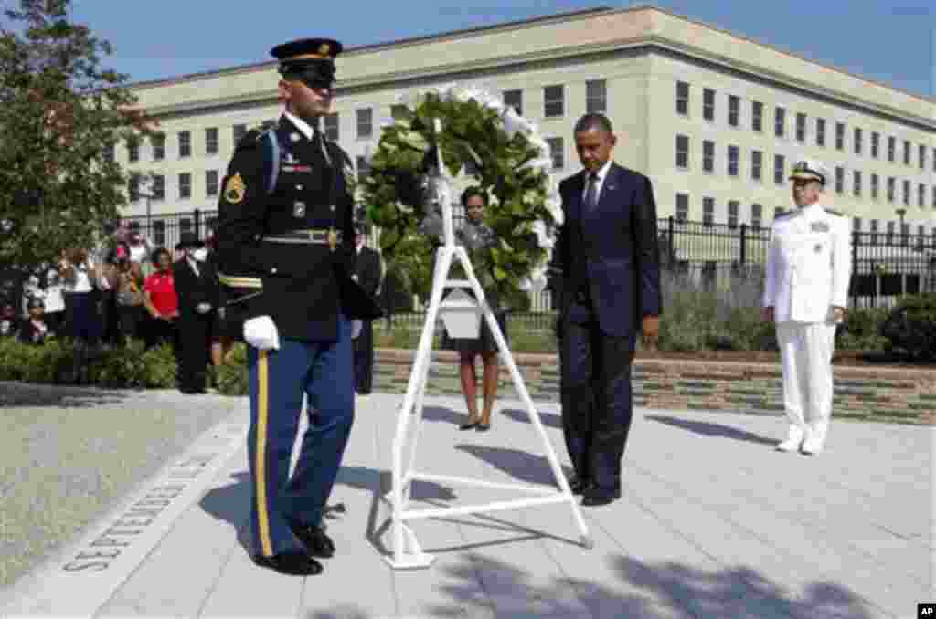 President Barack Obama and first lady Michelle Obama lay a wreath as the 10th anniversary of the September 11 attacks are observed at the Pentagon in Washington, Sunday, Sept. 11, 2011. At right is Chairman of the Joint Chiefs of Staff Adm. Mike Mullen. (