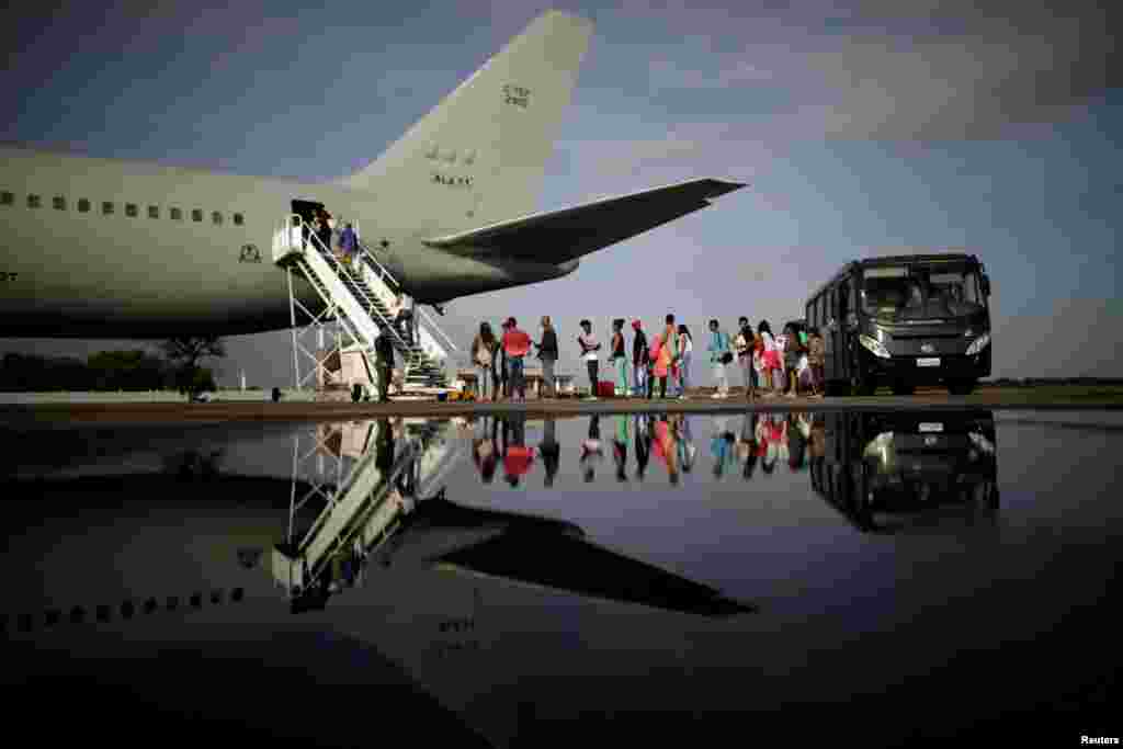 Venezuelan refugees board a Brazilian Air Force plane, heading to Manaus and Sao Paulo, at Boa Vista Airport, Brazil.