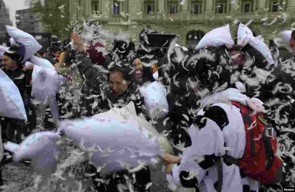 People take part in International Pillow Fight Day in central Bucharest, Romania.