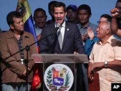 Venezuela's opposition leader and self proclaimed interim President Juan Guaido, center, speaks during a meeting with oil workers at the Metropolitan University of Caracas, Venezuela, May 3, 2019.