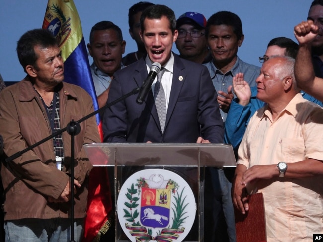 Venezuela's opposition leader and self proclaimed interim President Juan Guaido, center, speaks during a meeting with oil workers at the Metropolitan University of Caracas, Venezuela, May 3, 2019.