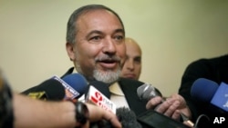 Former Israeli Foreign Minister Avigdor Lieberman speaks to journalists as he arrives to the weekly Cabinet meeting at the prime minister's office in Jerusalem, December 16, 2012.