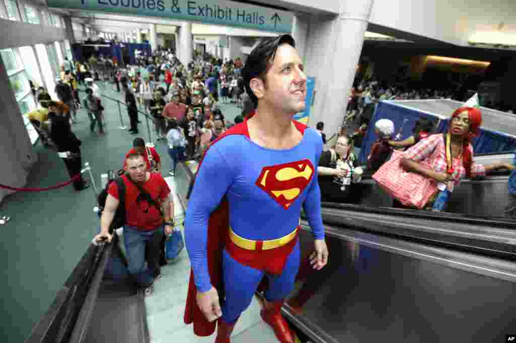 Trey Moore, dressed as Superman, rides the escalator on first day of Comic-Con convention held at the San Diego Convention Center, July 12, 2012, in San Diego.