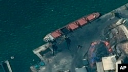 This satellite image provided by the Department of Justice shows what the DoJ says is the North Korean cargo ship Wise Honest docked at a unknown port. (Department of Justice via AP)