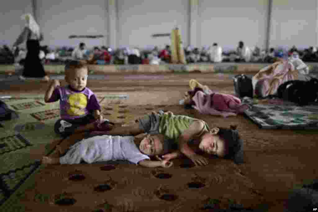 Syrian refugee children try to amuse themselves at a camp near the Turkish border in August of last year. 