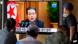 People watch a TV screen showing North Korean leader Kim Jong Un in a news program, at Seoul Railway Station in Seoul, South Korea, Sept. 30, 2021.