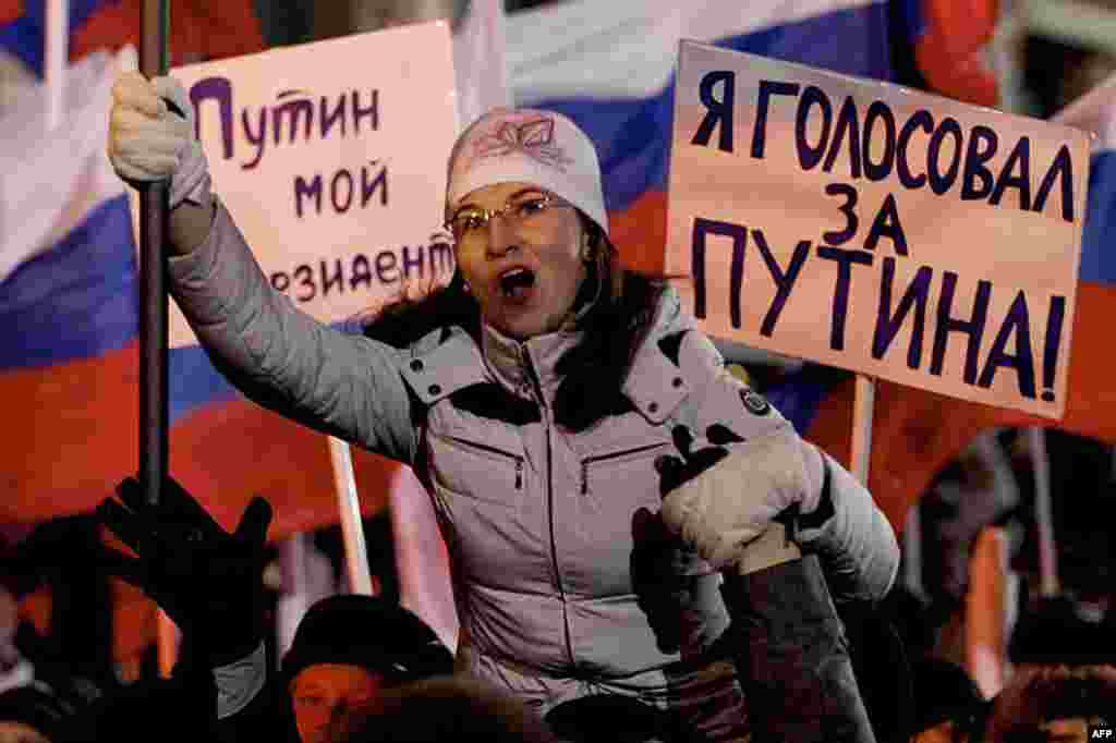 Supporters of Russian Prime Minister Vladimir Putin rally at Manezh square outside Kremlin, in Moscow, Russia, March 4, 2012. Posters read "Putin is my president," "I voted for Putin." (AP)