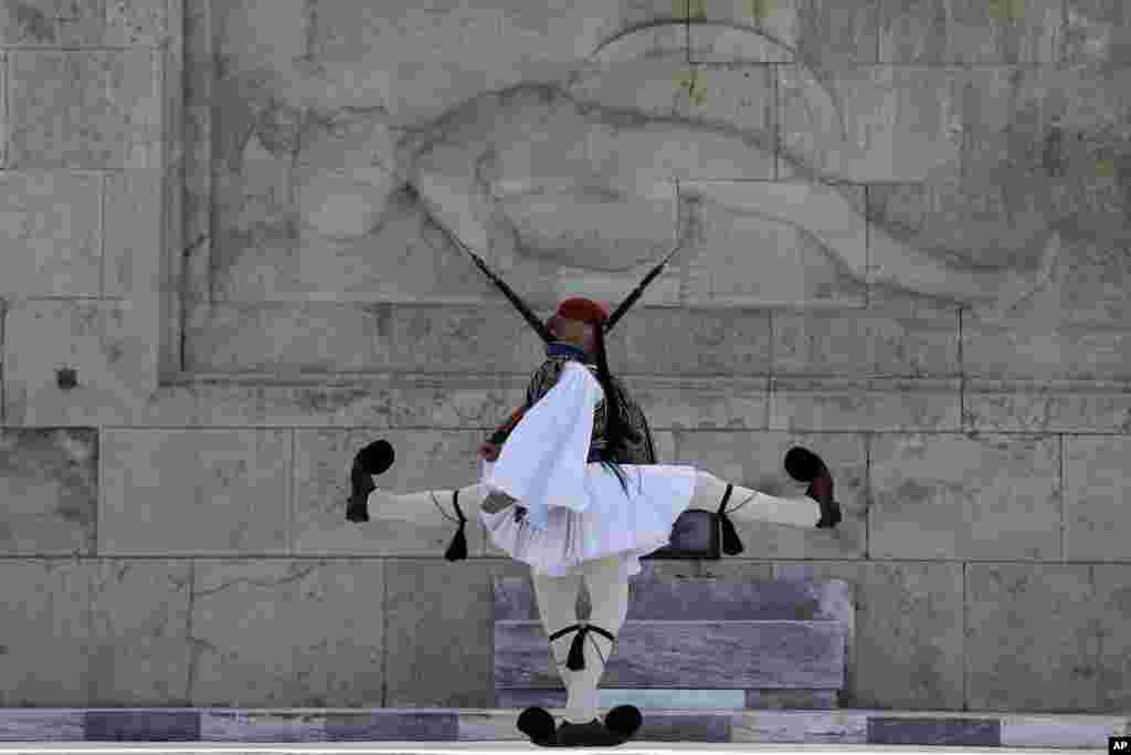 Members of the Presidential Guard perform in front of the Tomb of the Unknown Soldier in Athens, Greece.