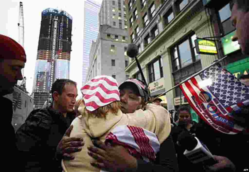 Dionne Layne, facing camera, hugs Mary Power as they celebrate the news of the death of Osama bin Laden, New York City, May 2, 2011; At left is the rising tower, 1 World Trade Center, also known as the Freedom Tower (AP)