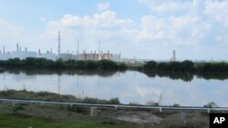 This Saturday, Sept. 2, 2017, photo shows the heavily polluted Patrick Bayou in the Houston Ship Channel that was flooded during Tropical Storm Harvey in Houston. The bayou, which sits next to a chemical plant in an intensely industrial area of Houston, is polluted with pesticides, hydrocarbons, metals and polychlorinated biphenyls (PCBs). 