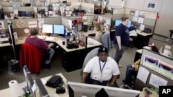 In this 2007 file photo, employees of PayPal work in their cubicles in La Vista, Nebraska.