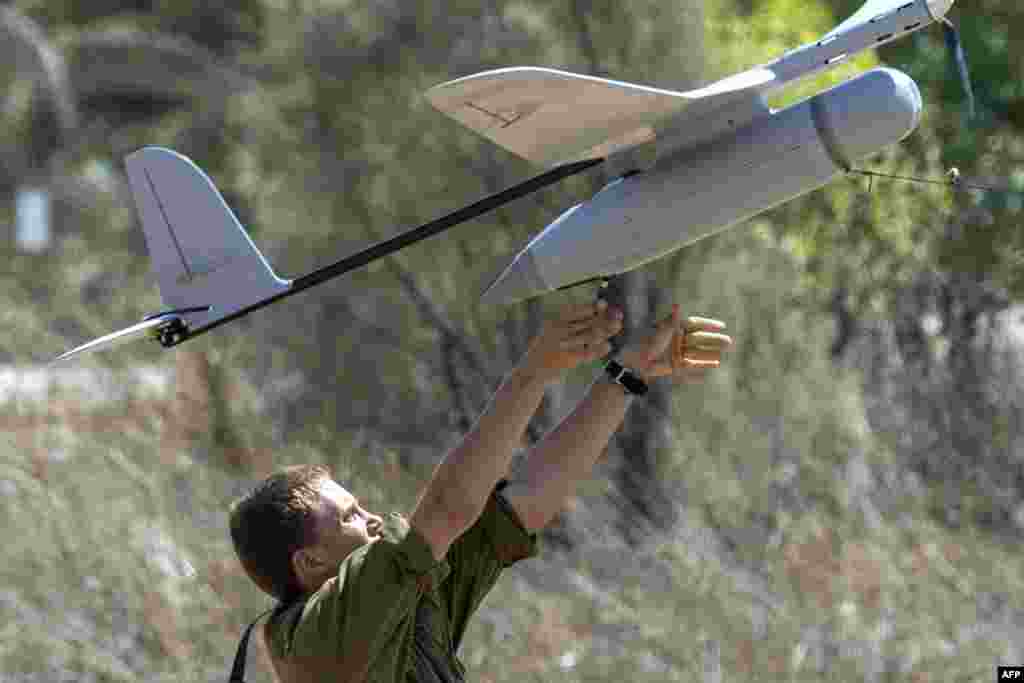 An Israel soldier prepares to launch an Israeli army's Skylark I unmanned drone aircraft, which is used for monitoring purposes on July 14, 2014 at an army deployment area near Israel's border with the Gaza Strip. I