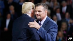 President Donald Trump on stage with Republican gubernatorial candidate Secretary of State Kris Kobach during a campaign rally at Kansas Expocentre, Oct. 6, 2018 in Topeka, Kan.