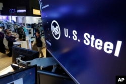 FILE - The logo for U.S. Steel appears on a screen above the trading floor of the New York Stock Exchange.