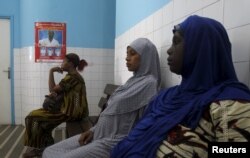 Women sit at a maternity hospital in Treichville, Abidjan, Ivory Coast, May 28, 2015.