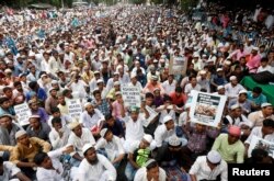 People attend a protest rally against what they say are killings of Rohingya people in Myanmar
