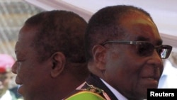 Zimbabwean President Robert Mugabe (R) and Prime Minister Morgan Tsvangirai arrive at a rally marking Zimbabwe's 31st independence anniversary celebrations in Harare (File Photo - April 18, 2011)